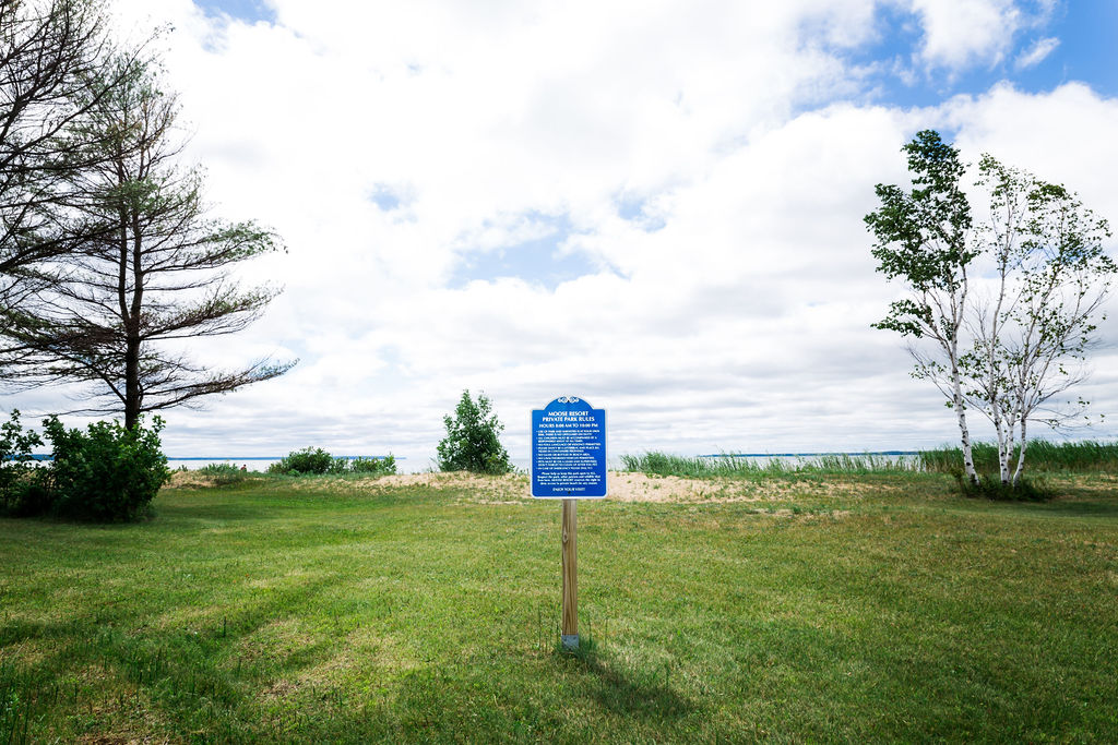 Moose Resort private beach sign at the edge of the lawn