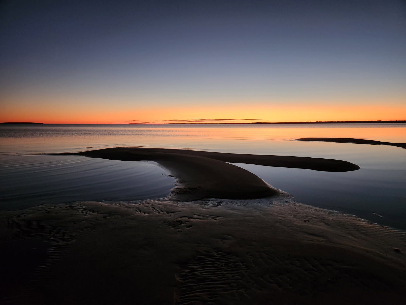 Sandbars and still water at twilight on the lake