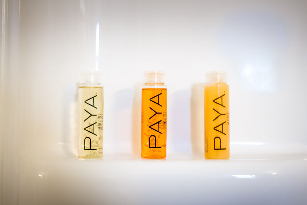 PAYA toiletry trio lined up on the tub edge