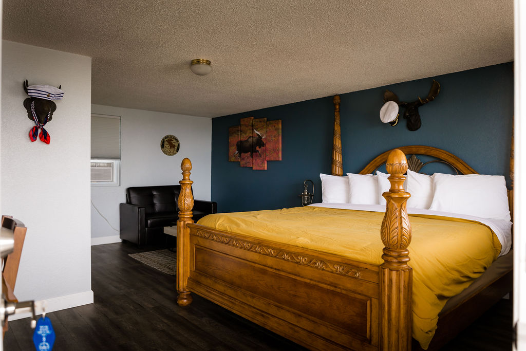 King bedroom with leather chair, moose canvas, and sailor moose decor