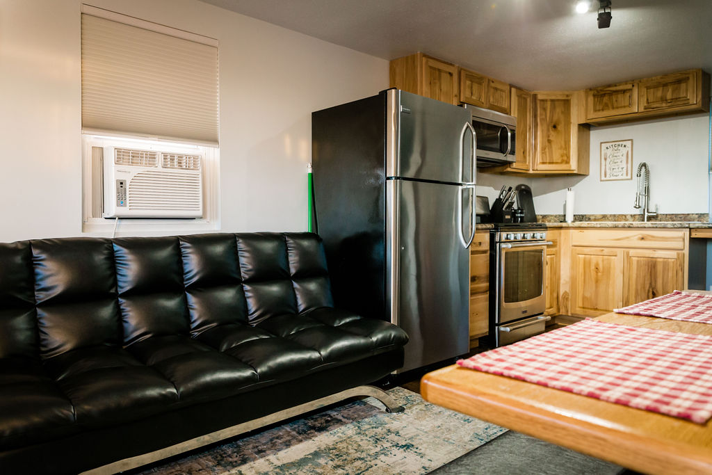 Black leather futon couch in open living area