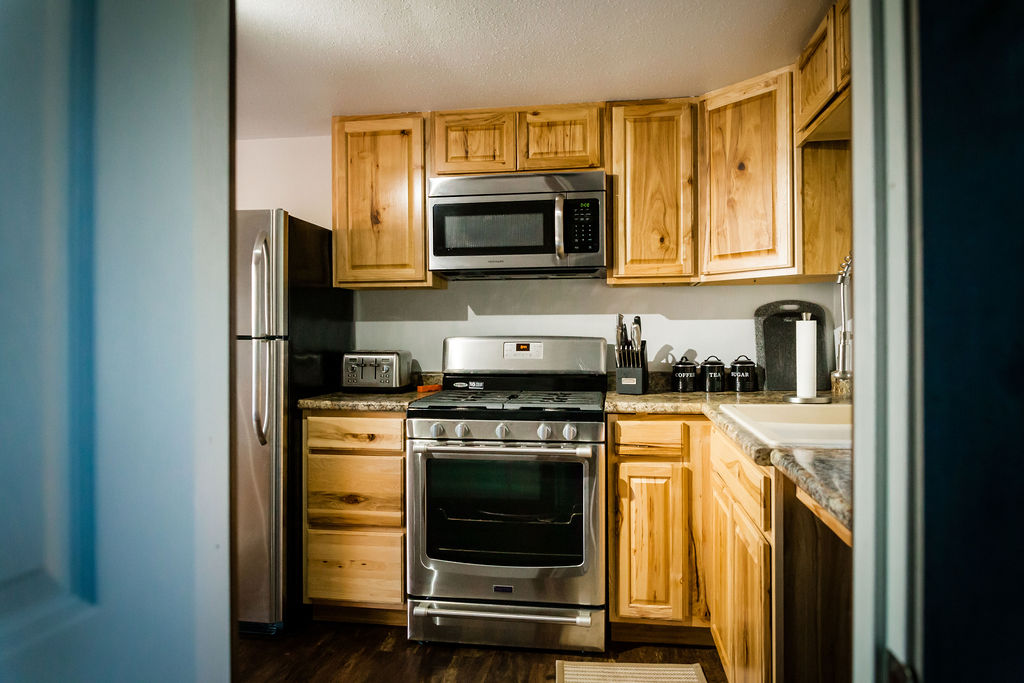 Full kitchen with hickory cabinets and stainless appliances